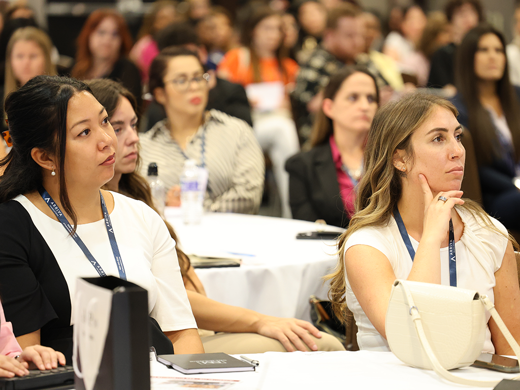 Conference attendees in session